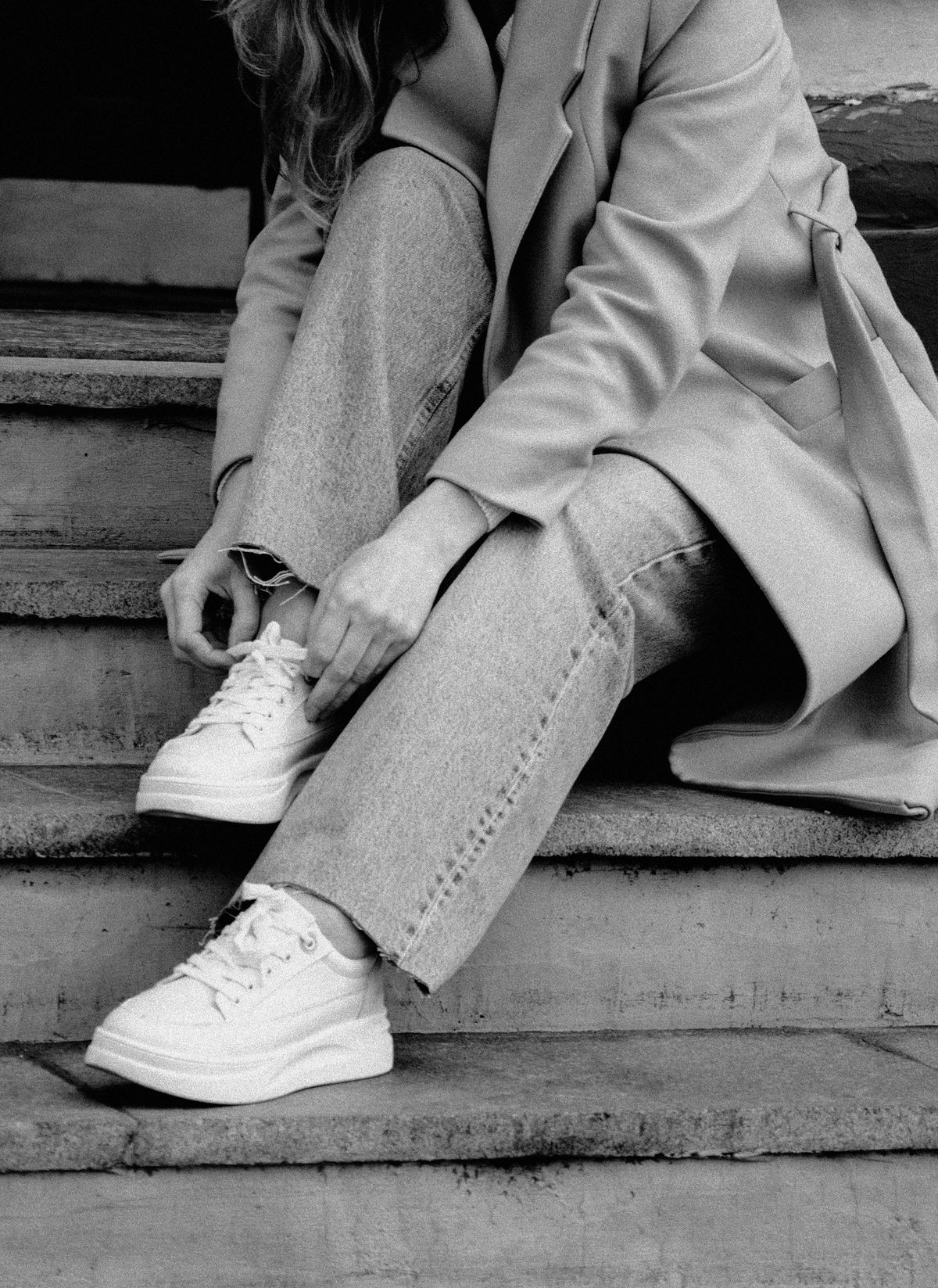 Sneakers donna bianche chunky abbinate a un cappotto, tendenza autunno inverno 2026-2027
