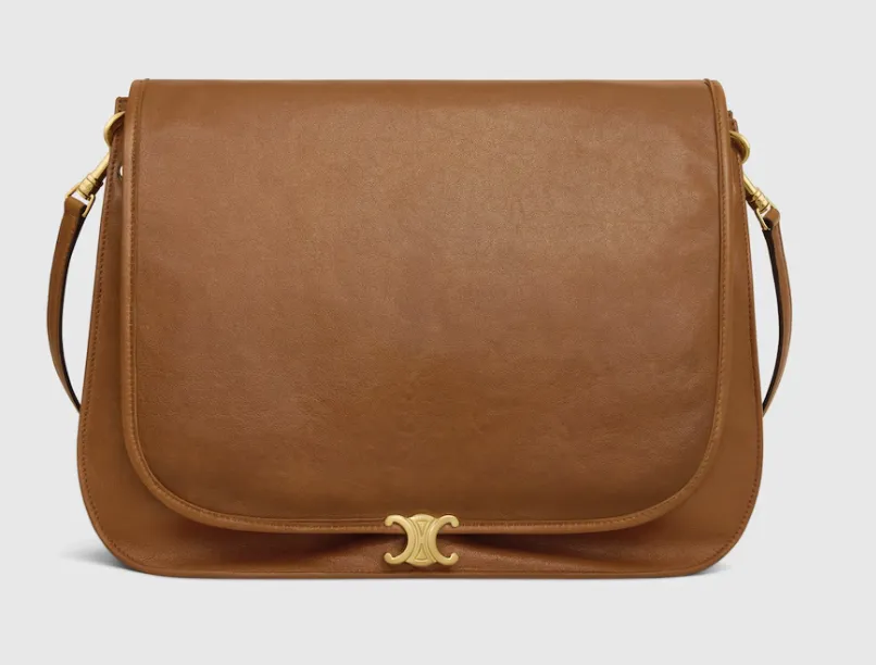 Celine Triomphe clasp on a tan calfskin flap bag