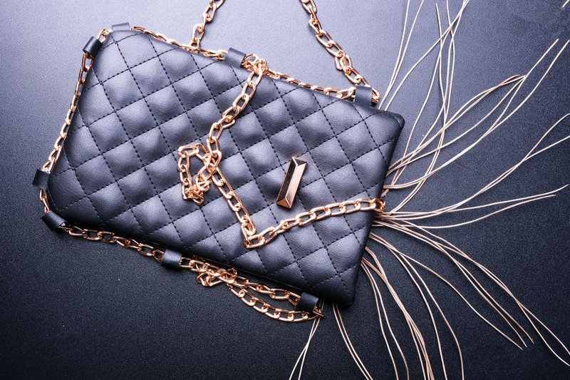 Gold chain strap lying across a quilted leather bag
