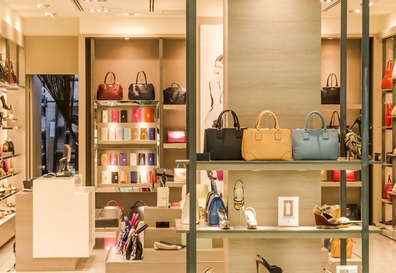 Handbags stored upright and spaced apart on shelves