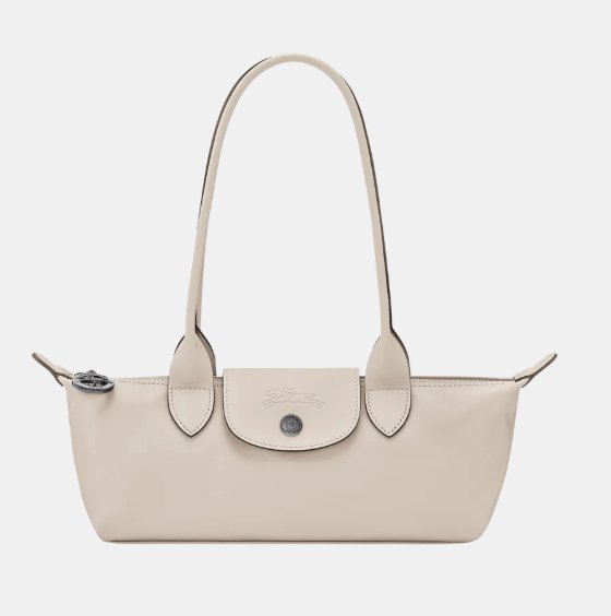 Chalk-coloured Longchamp Le Pliage leather shoulder bag showing the flap, the press stud and the two side ears