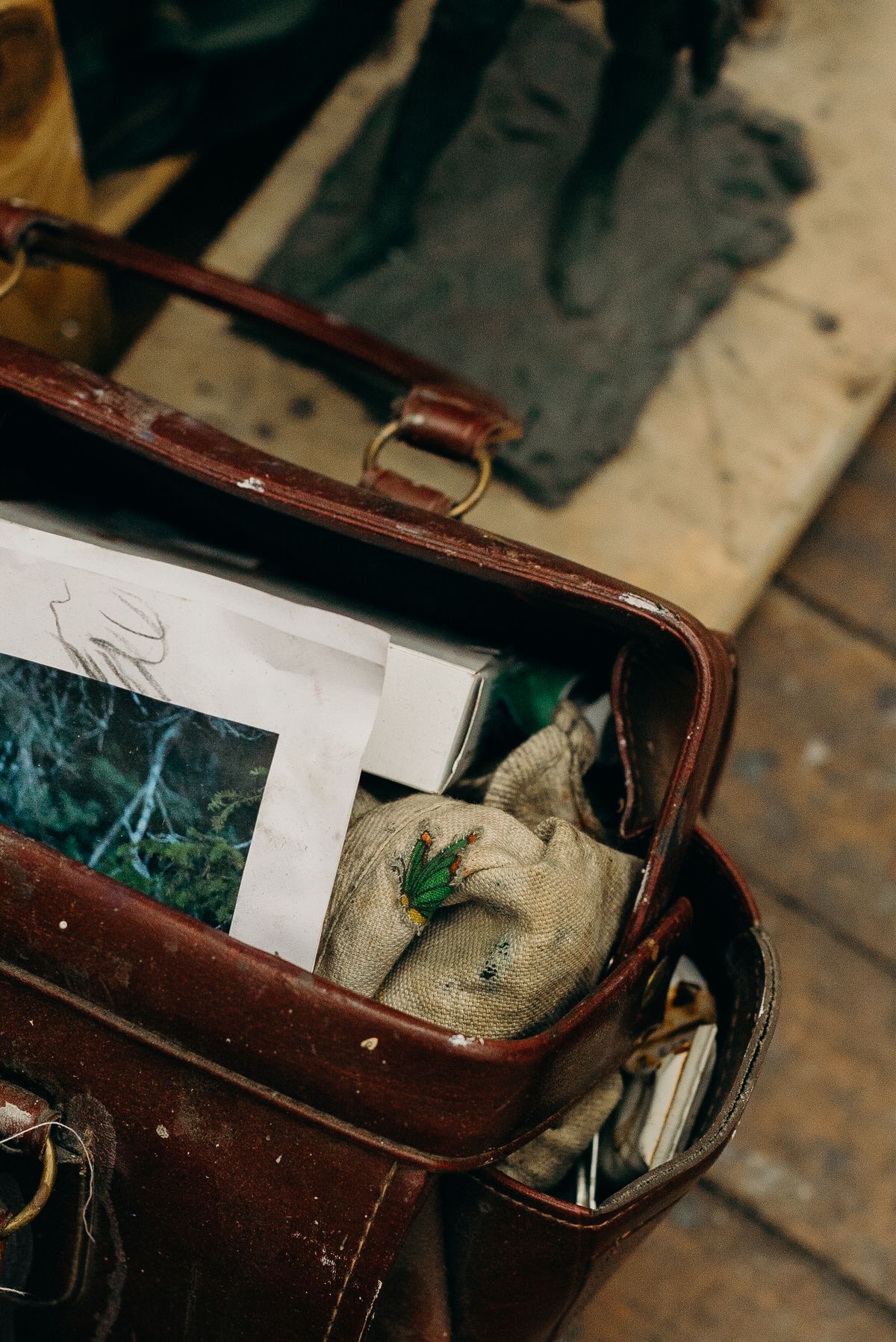 Old leather bag showing scuffs and patina after years of use