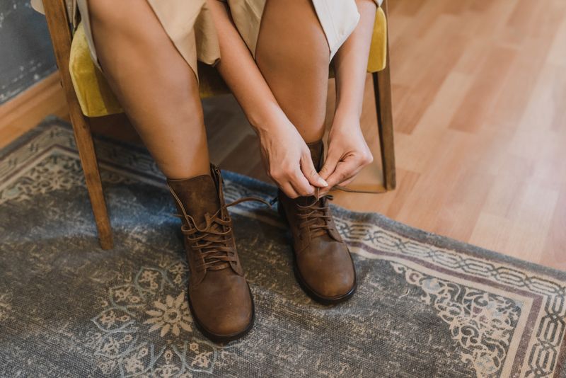 Stivaletti in pelle marrone allacciati in casa, il momento giusto per impermeabilizzare le scarpe in pelle